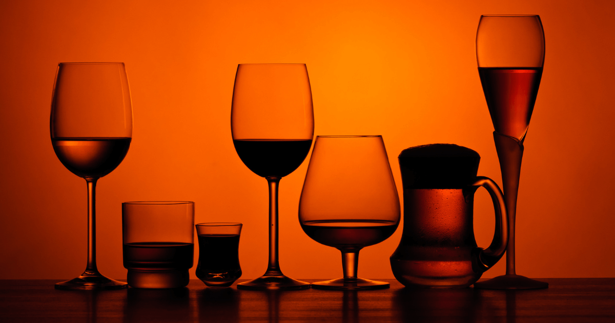 glasses showing alcoholic drinks with an orange background